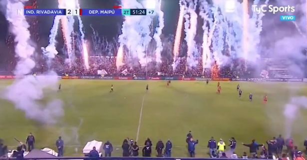 Football game looks like it's being played in a 'warzone' as fans let off fireworks